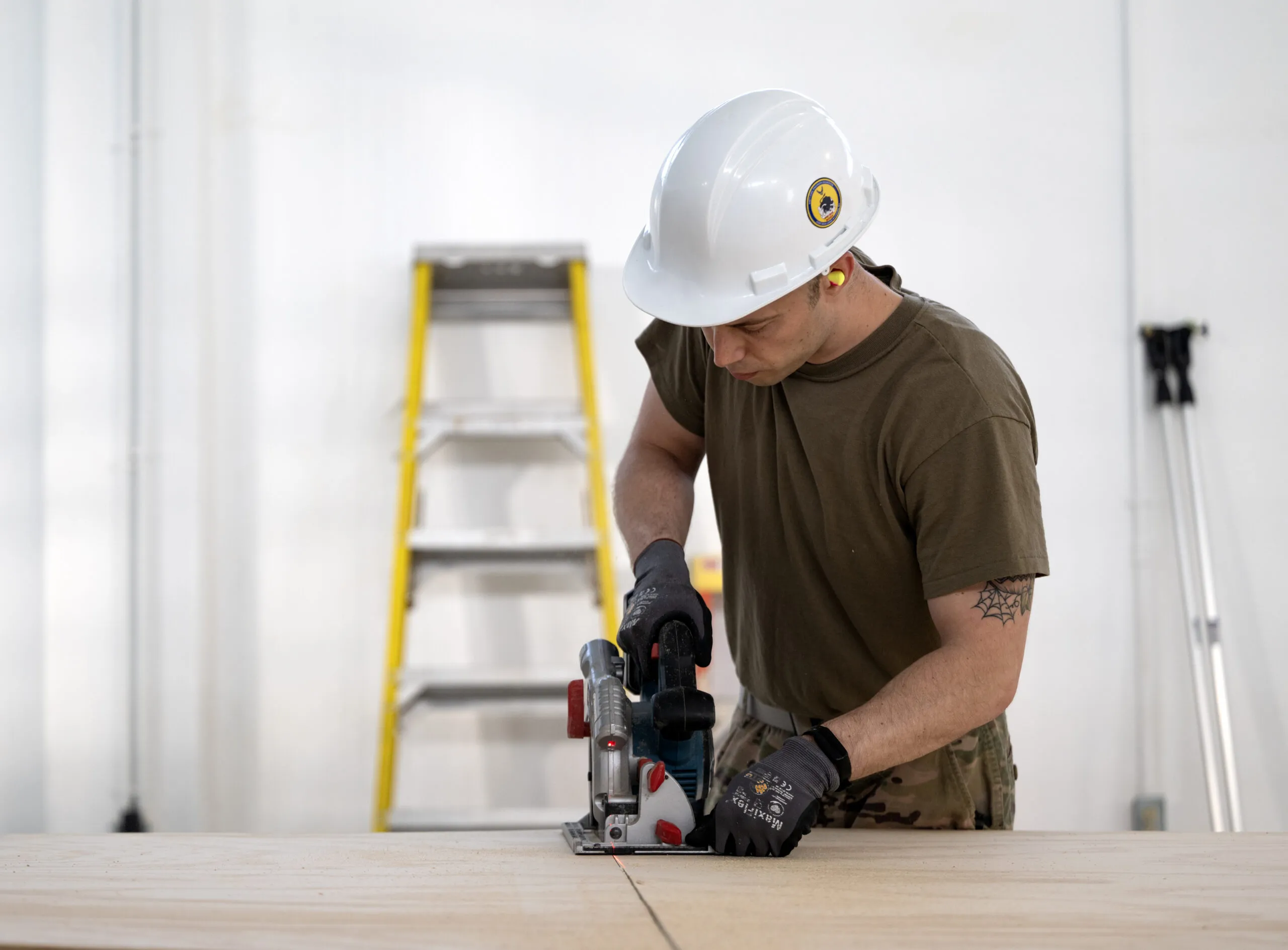 Staff Sgt. Michael Simon, 446th Civil Engineer Squadron HVAC NCOIC, cuts wood for a wall panel at Moron Air Base, Spain, on May 8, 2025. The 446th CES worked to build a dark room for the Security Forces team on the installation. (U. S. Air Force photo by Capt. Daniel Phelps)