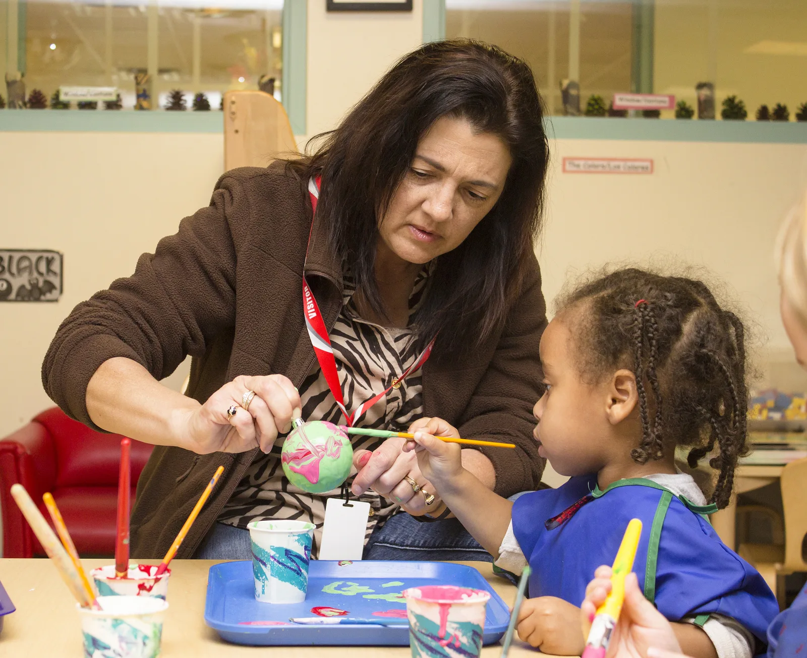 Holly Dailey paints Christmas tree ornaments with children at the Cody Child Development Center Nov. 12 on the Fort Myer portion of Joint Base Myer-Henderson Hall. Dailey and Hollyanne Milley, both residents of JBM-HH, visited the center to decorate Christmas ornaments with two preschool classes. (Joint Base Myer-Henderson Hall PAO photo by Delonte Harrod)
Unit: Joint Base Myer-Henderson Hall
