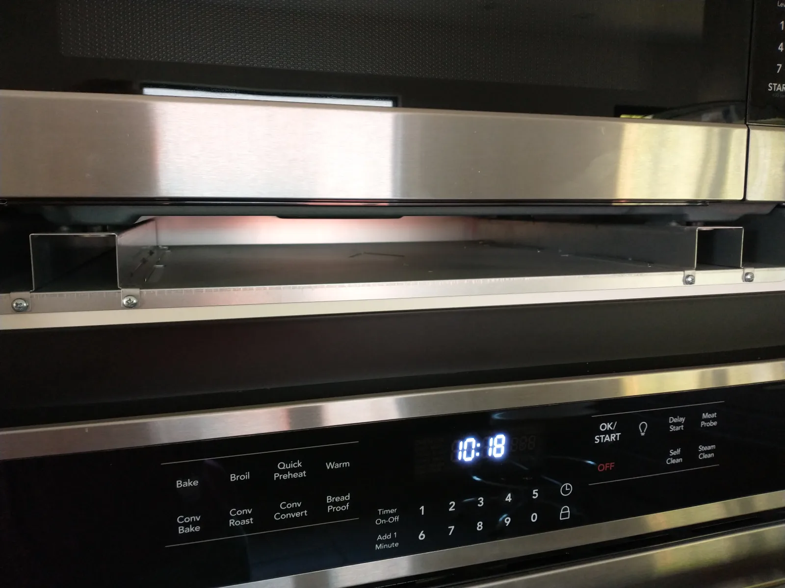 The installation of a microwave oven into one of Ikea's "Sektion" kitchen cabinet frames requires a number of special parts which are shown in this series of photos. The most obvious is a rectangular trim which covers the gaps that otherwise would remain between the appliance and the cabinet's sides and shelves.