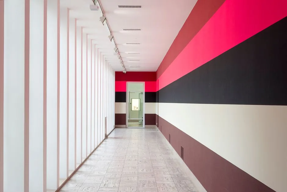 Sleek interior corridor featuring bold horizontal stripes and modern architecture.