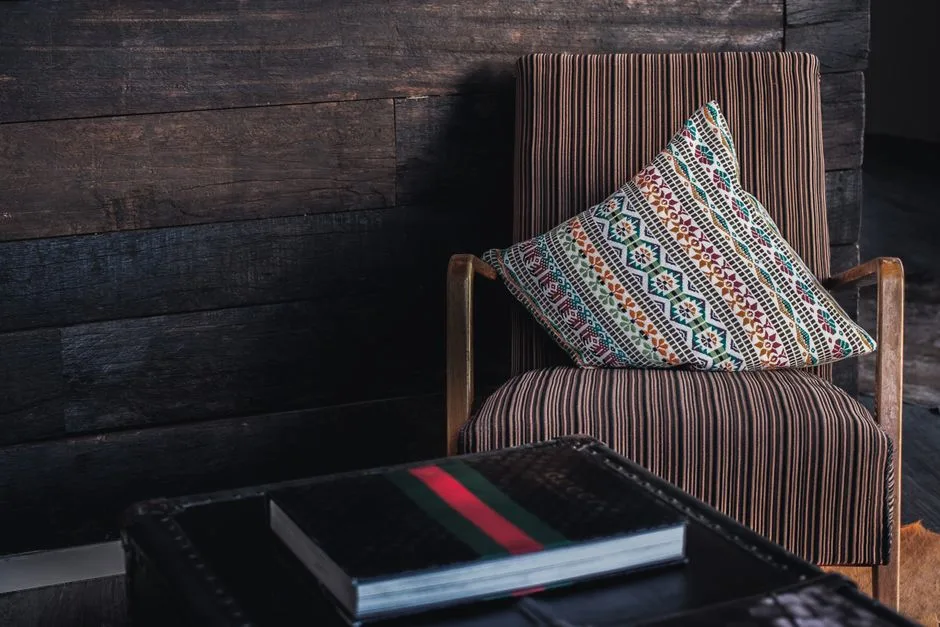 Rustic wooden armchair with a patterned pillow adds a cozy touch to this Berlin interior.
