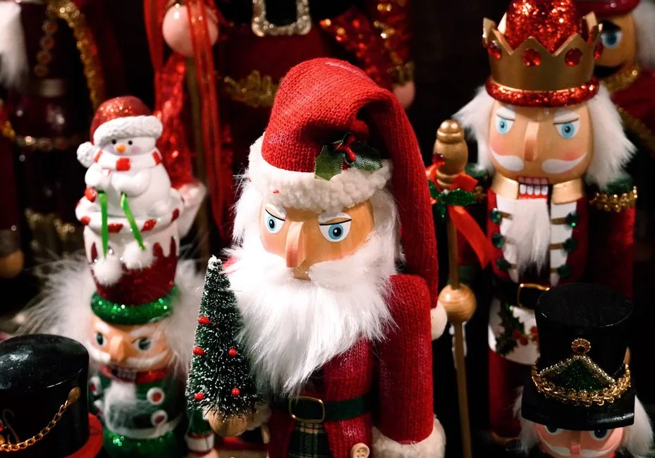 Close-up of colorful Christmas nutcrackers, including Santa and a snowman, with detailed decorations.