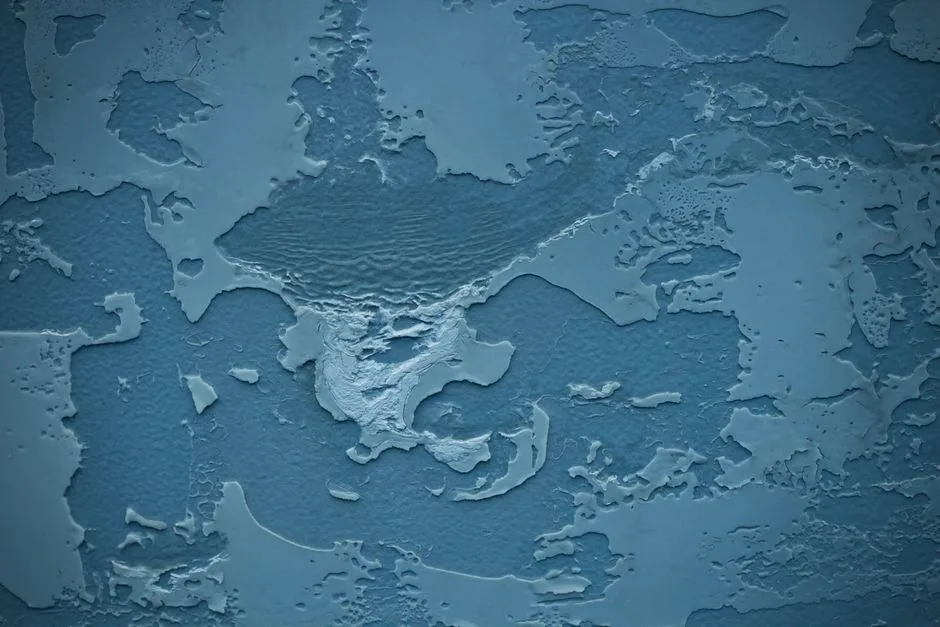 Textured blue plaster surface resembles a map with intricate details and patterns.
