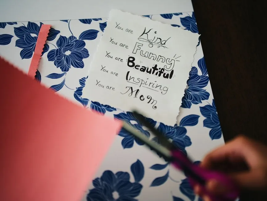 A beautifully crafted card celebrates motherhood with floral patterns and a heartfelt message.