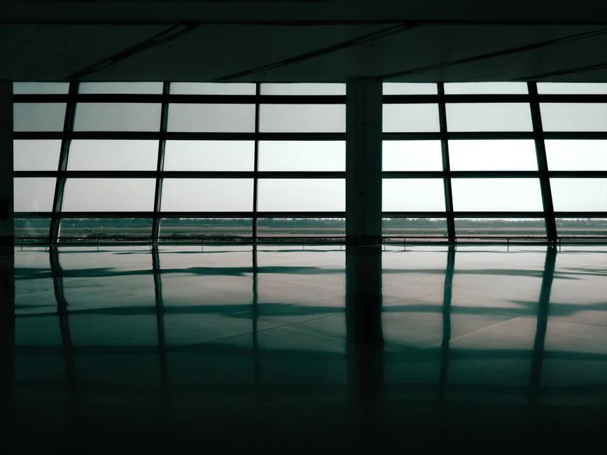 Spacious airport terminal window reflections create a geometric and architectural effect.
