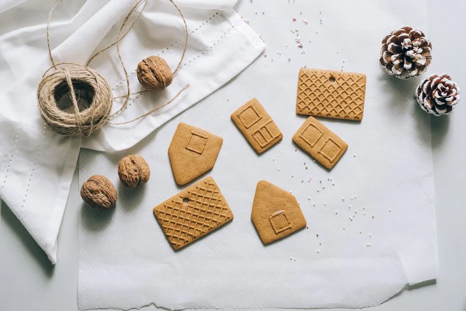 Various gingerbread pieces ready for assembly into a festive house, perfect for holiday baking.