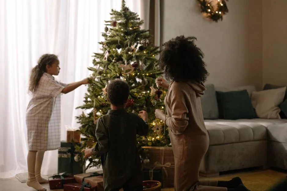 Cozy family moment decorating a Christmas tree indoors during the holiday season.