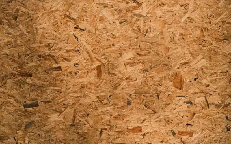 Detailed close-up texture of oriented strand board (OSB) with rich brown tones and intricate patterns.