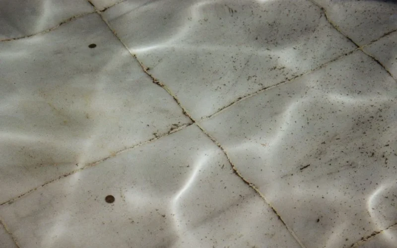 Detailed view of dirty, textured swimming pool tiles underwater in Saint Petersburg, Russia.