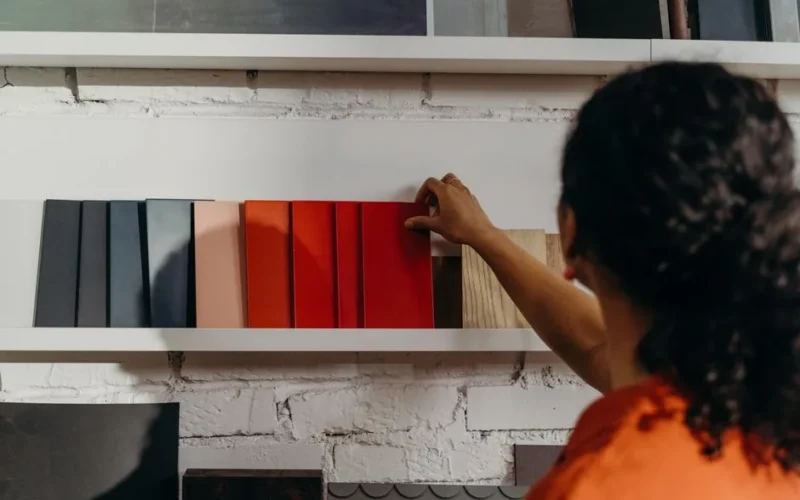 A woman chooses from an array of color samples in a design showroom.