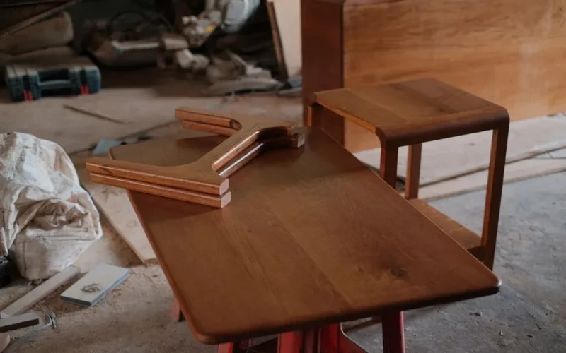 Wooden furniture pieces on a workshop table, demonstrating craftsmanship.