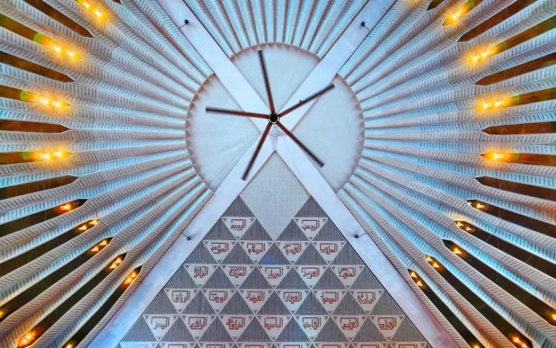 Detailed view of an ornate ceiling, showcasing geometric patterns and artistic lighting.