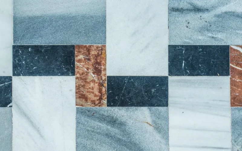 Close-up of a geometric marble tile pattern with natural texture colors.