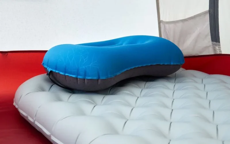 Detailed view of inflatable pillow on sleeping pad inside a tent, perfect for outdoor adventures.