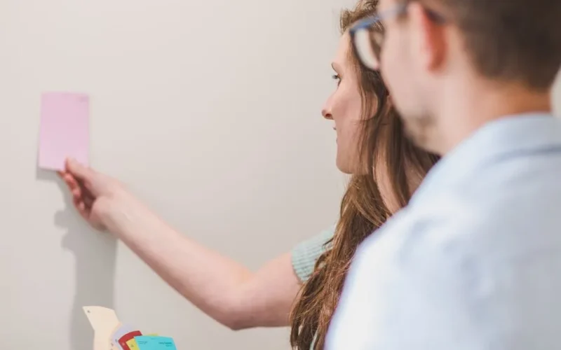 A couple deliberates on paint color selections for their home interior renovation project.