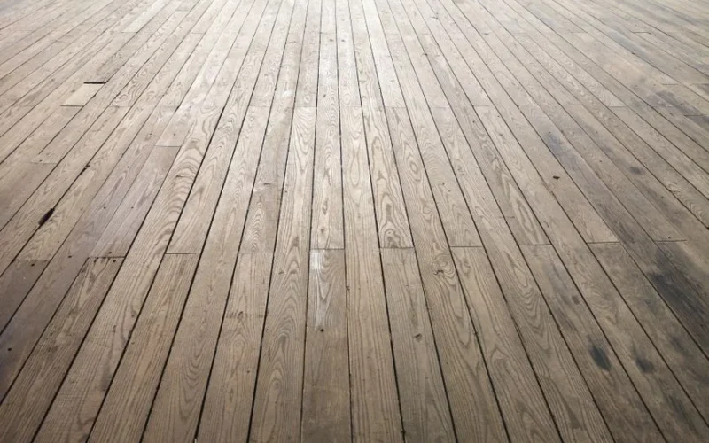 A wide angle view of aged wooden floor planks showing natural texture and grain pattern.