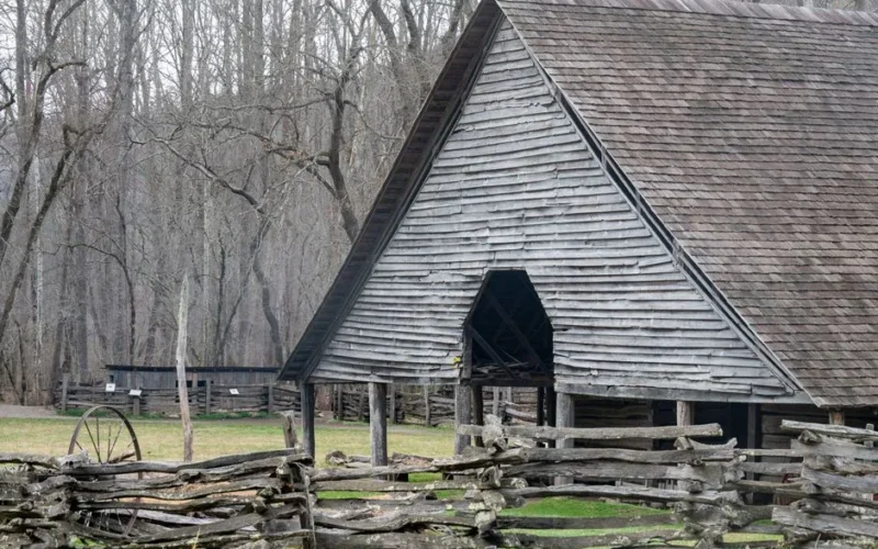 Historic wooden barn with split-rail fence in Great Smoky Mountains National Park.