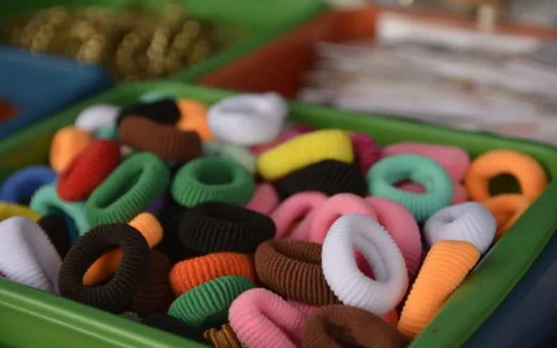 Vibrant collection of colorful hair bands displayed in a green box.