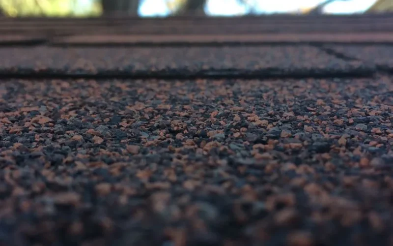 Artistic close-up of roof shingles showcasing texture and depth of field with bokeh background.