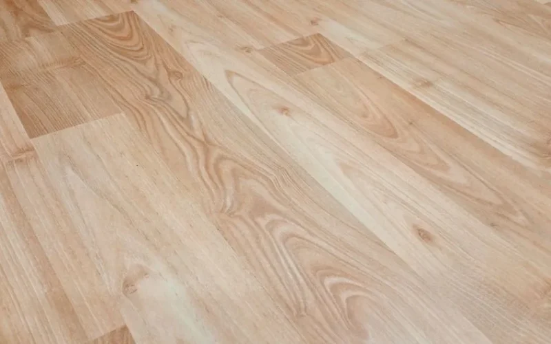 Smooth light brown wooden flooring with natural texture and patterns.