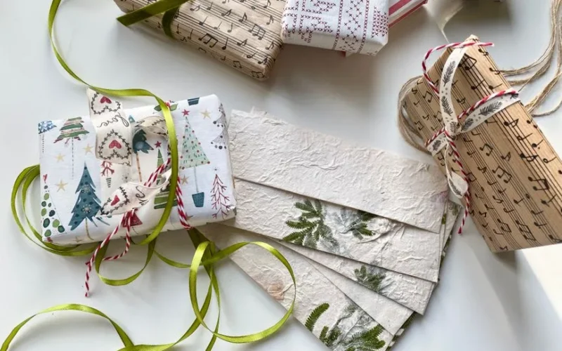 High-angle view of creatively wrapped Christmas gifts and decorative paper, perfect for holiday inspiration.